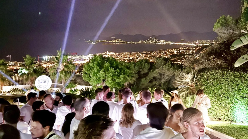 White-clad guests dance poolside at the rAAVE party in Cannes. MacKenzie Sigalos